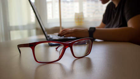 Beautiful glasses. Work from home. Business woman hand working on blank screen laptop computer on...