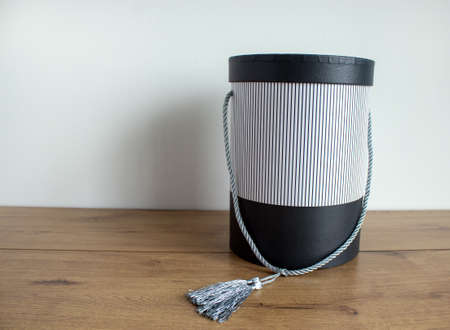 Round gift box on a wooden table on a white background. Copy space.の写真素材