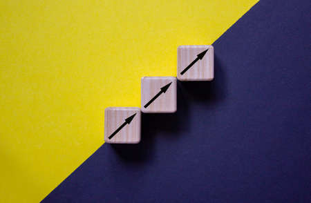 Business concept growth success process. Wood block stacking as step stair on paper yellow and black...