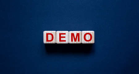 Concept word 'demo' on cubes on a beautiful dark background. Business concept.