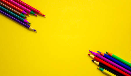 Color pencils on a beautiful yellow background. Copy space. Education concept.