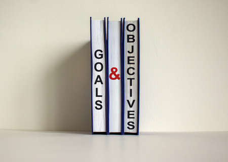 Books with text 'goals and objectives' on beautiful white background. Business concept. Copy space.の写真素材