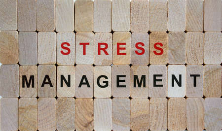 Wooden blocks form the words 'stress management'. Beautiful wooden background.の写真素材
