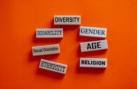 Diversity ethnicity gender age sexual orientation religion disability words written on wooden block....