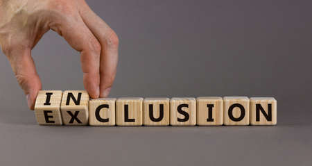 Symbol for a better inclusion. Male hand turns cubes and changes word exclusion to inclusion....
