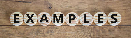 Wooden small circles with word examples on beautiful wooden background. Business concept.の写真素材