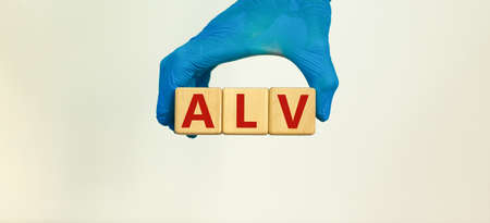 Medical and COVID-19 Pandemic Coronavirus concept. Hand in blue glove holds wooden cubes with the...