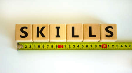 'Skills' word on cubes arranged behind the ruler on beautiful white background. Business concept,...