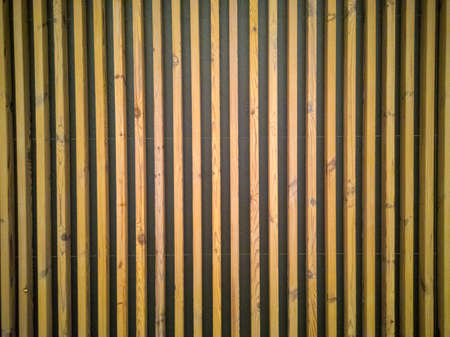 Seamless pattern of modern wall paneling with vertical wooden slats for background. Raw material of...