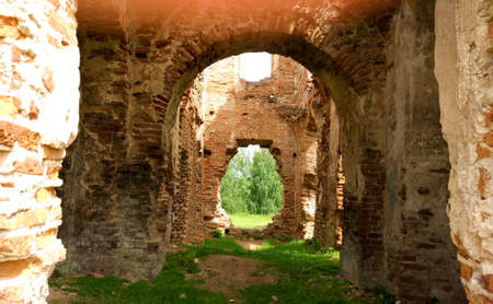 Historical walls on a narrow alleyway. Tourism and Travel concept. Corridors or roads between walls in the old castle. Sunshine.の写真素材