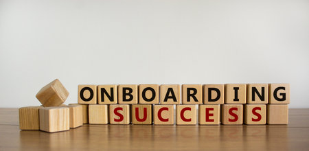Time to success onboarding. Words 'Onboarding success' written on wooden blocks. Business and success onboarding concept. Beautiful wooden table, white background. Copy space.の写真素材