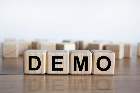 Demo symbol. Concept word 'demo' on cubes on a beautiful wooden table. White background. Business and demo concept. Copy space.の写真素材