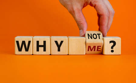 Why not me symbol. Businessman turns a cube and changes words why me to why not. Beautiful orange background. Business and why not me concept. Copy space.の写真素材