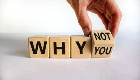Why not you symbol. Businessman turns a cube and changes words why you to why not. Beautiful white background. Business and why not you concept. Copy space.の写真素材