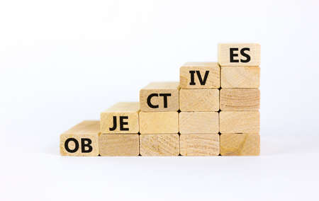 Objectives symbol. Wooden blocks stacking as step stair on white background, copy space. Word 'objectives'. Business and objectives concept.の写真素材