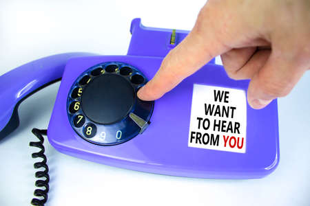 We want to hear from you symbol. Old blue rotary dial telephone. Words 'We want to hear from you'. Beautiful white background. Business, help is here and support concept, copy space.の写真素材