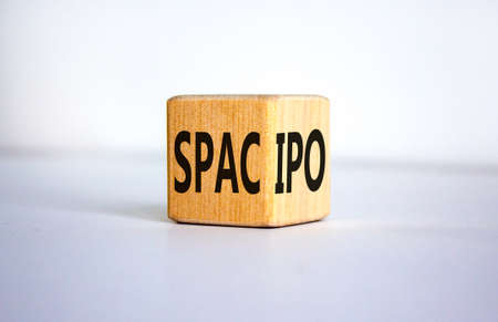 SPAC vs IPO symbol. Wooden cube with words 'SPAC, special purpose acquisition company' and 'IPO,...