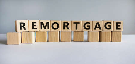 Remortgage symbol. The word 'Remortgage' written on wooden cubes. Business and remortgage concept. Copy space. Beautiful white table, white background.の写真素材