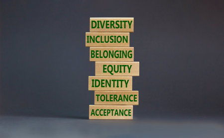 Diversity, inclusion symbol. Diversity belonging inclusion equity identity tolerance acceptance words written on wooden block. Beautiful gray background. Diversity, inclusion and belonging concept.の写真素材