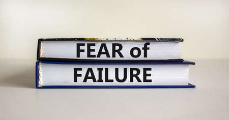Fear of failure symbol. Books with words 'fear of failure'. Beautiful white background, copy space. Business, fear of failure concept.の写真素材
