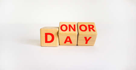 Donor day symbol. Turned wooden cubes with words 'Donor day'. Beautiful white background. Donor day...