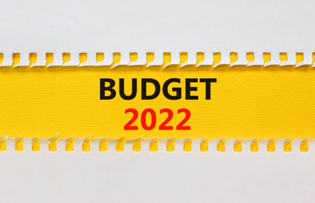 2022 budget new year symbol. White and yellow paper with words '2022 budget'. Beautiful yellow background. Business and 2022 budget new year concept. Copy space.の写真素材