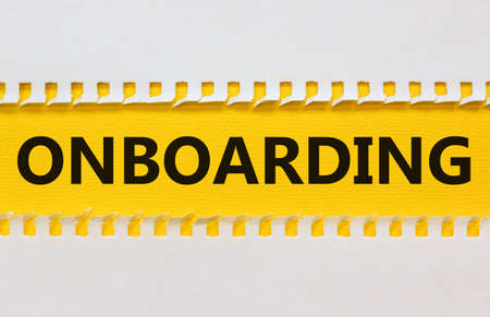 Onboarding success symbol. White and yellow paper with the word Onboarding on beautiful yellow background. Business and onboarding success concept. Copy space.の写真素材