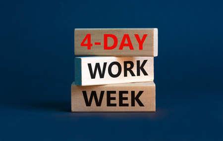 4-day work week symbol. Concept words '4-day work week' on wooden blocks. Beautiful grey background. Copy space. Business and 4-day work week concept.の写真素材
