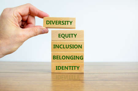 Diversity, equity, inclusion, belonging, identity symbol. Wooden blocks with words Diversity, equity, inclusion, belonging, identity on beautiful white background. Business, Inclusion concept.の写真素材