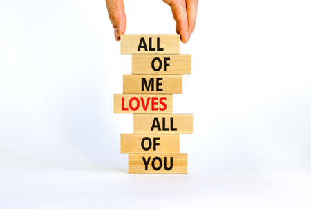 All of me loves all of you symbol. Wooden blocks with words All of me loves all of you on beautiful white background, copy space. Businessman hand. Lifestyle, love concept.の写真素材