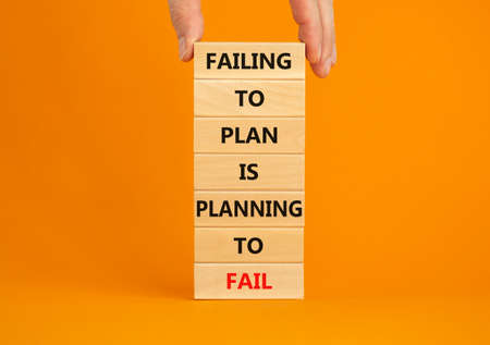 Failing to plan or planning fail symbol. Wooden blocks with words Failing to plan is planning to fail. Beautiful orange background, copy space. Business, failing to plan planning fail concept.の写真素材