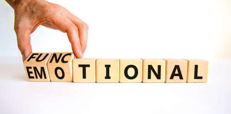Functional or emotional symbol. Businessman turns wooden cubes and changes the word emotional to...
