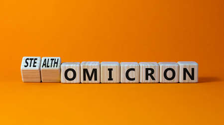 Covid-19 stealth omicron symbol. Turned cubes and changed words omicron to stealth omicron. Beautiful orange background. Medical, covid-19 corona new stealth omicron variant concept. Copy space.の写真素材