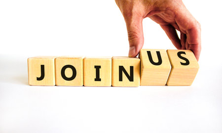 Join us symbol. Businessman turns wooden cubes and changes concept words Join to Join us. Beautiful white background. Business support and join us concept. Copy space.の写真素材