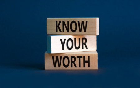 Know your worth symbol. Concept words Know your worth on wooden blocks. Beautiful grey table grey background. Business and know your worth concept. Copy space.の写真素材