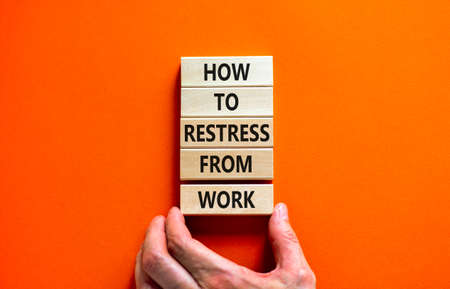 Restress from work symbol. Concept words How to restress from work on wooden blocks. Doctor hand. Beautiful orange background. Psychological business and restress from work concept. Copy space.の写真素材
