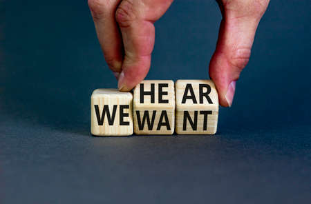 We hear and want symbol. Concept words We hear we want on wooden cubes. Businessman hand. Beautiful grey table grey background. Business and we hear and want concept. Copy space.の写真素材