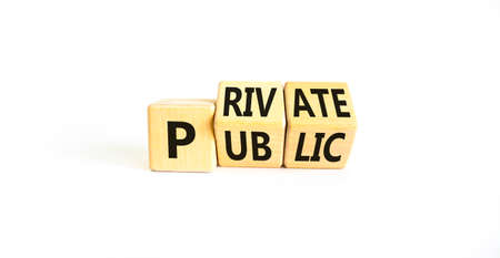 Private or public symbol. Concept words Private or Public on wooden cubes. Beautiful white table...