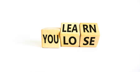 You learn or lose symbol. Concept words You learn and You lose on wooden cubes. Beautiful white...