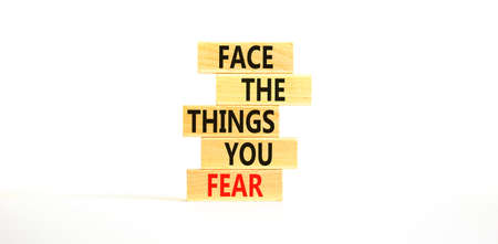 Face the things you fear symbol. Concept words Face the things you fear on wooden blocks on a beautiful white table white background. Business and face the things you fear concept. Copy space.の写真素材