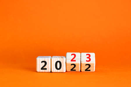 2023 happy new year symbol. Wooden cubes symbolize the change from 2022 to the new year 2023....