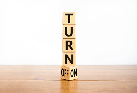 Turn on or off symbol. Concept words Turn off and Turn on on wooden cubes. Beautiful wooden white background. Business Turn on or off concept. Copy space.の写真素材