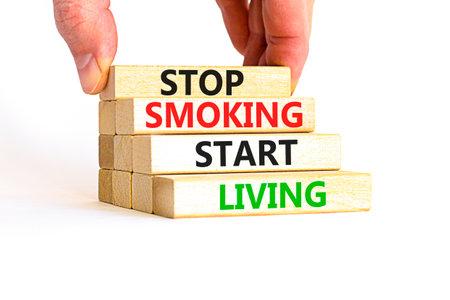 Stop smoking start living symbol. Concept words Stop smoking start living on cubes. Beautiful white background. Doctor hand. Medical healthy lifestyle stop smoking start living concept. Copy space.の写真素材