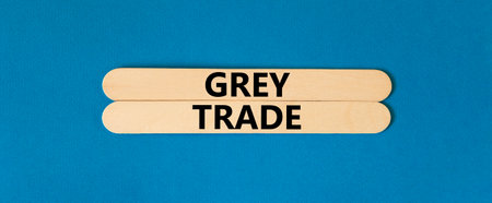 Grey trade symbol. Concept words Grey trade on wooden sticks. Beautiful blue table blue background....