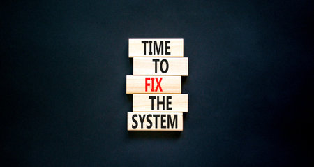 Time to fix the system symbol. Concept words Time to fix the system on wooden block. Beautiful black table black background. Business and time to fix the system concept. copyspace.の写真素材