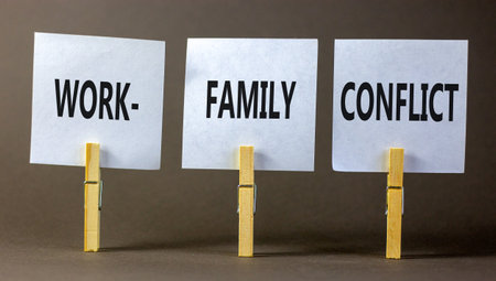 Work-family conflict symbol. Concept words Work-family conflict on white paper on wooden clothespin on a beautiful gray table gray background. Business work-family conflict concept. copyspace.の写真素材