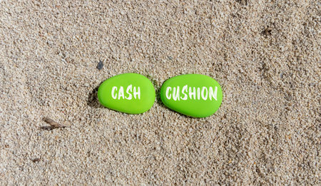 Cash cushion symbol. Concept words Cash cushion on beautiful green stone. beautiful sand sea beach background. Business and cash cushion concept. copyspace.の写真素材