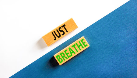 Just breathe and psychological symbol. Concept words Just breathe on beautiful wooden block. Beautiful white and blue background. Business psychological and Just breathe concept. copy spaceの写真素材
