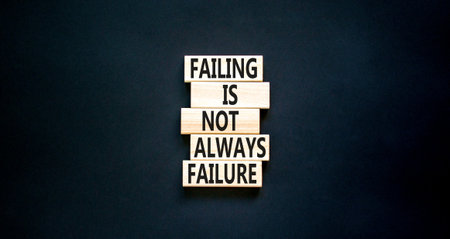 failure or fail symbol. Concept words Failing is not always failure on wooden block. Beautiful black table black background. Business, failure or failing concept. copyspace.の写真素材