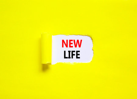 New life symbol. Concept words New life on beautiful white paper on a beautiful yellow background. Business, support, motivation, psychological and new life concept. copyspace.の写真素材